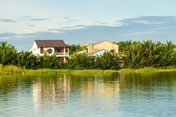 Fototapeta na wymiar Houses along the Thu Bon river near Hoi An