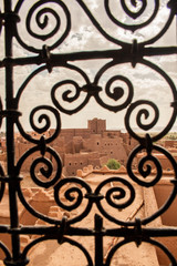 Moroccan tipical kasbah beyond window grate