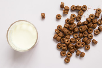 Top view of chocolate cereal with milk on blue background.