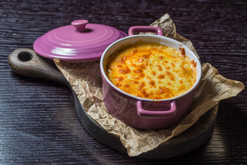creamy casserole in a purple pot on the board