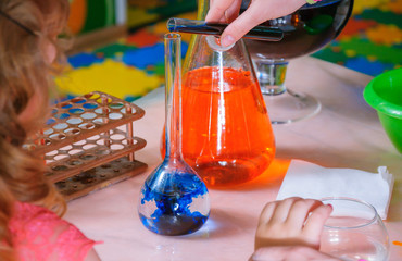 Different laboratory glassware with color liquid. Closeup.
