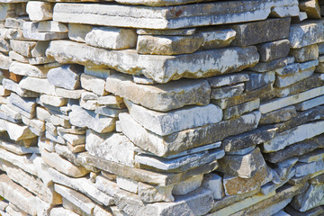 Stone wall built with blocks and marble slabs 