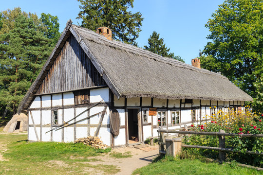 Kluki in polish Pomerania -wooden traditional Polish cottage in Kluki  and colorful flower garden 