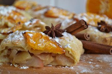 Apple strudel with orange slices and spices.