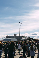 crowd of people and combat planes airshow performance - obrazy, fototapety, plakaty