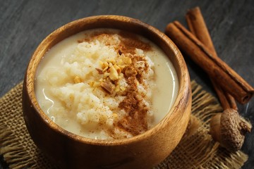 Rice pudding topped with nuts and cinnamon powder, selective focus