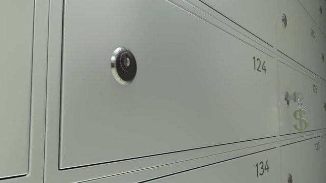 Multiple safe deposit boxes in a bank and inserted key with golden dollar sign keychain. 4K dolly shot