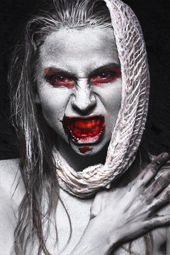 Girl in the form of zombies, Halloween corpse with blood on his lips. Image for a horror film. Photos shot in studio