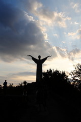 Cristo redentore in controluce con sole dietro e nuvole, Maratea, Ita
