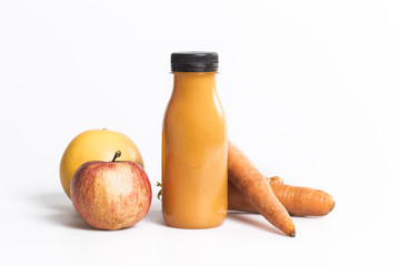 Orange juice made of fruits and carrots isolated on a white background
