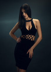 Naklejka premium Sexy girl in black skin-tight dress