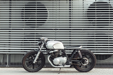 Obraz premium motorcycle standing in dark building in rays of sunlight