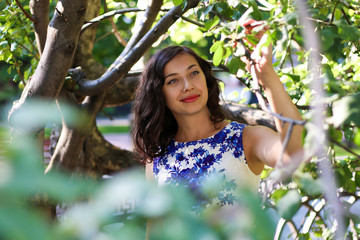 A beautiful young woman in the branches of trees