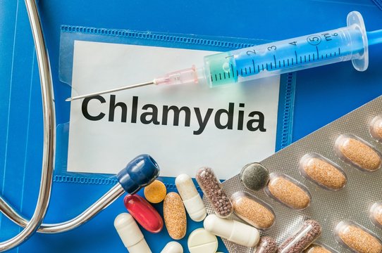 Chlamydia desease concept. A lot of pills and syringe around.