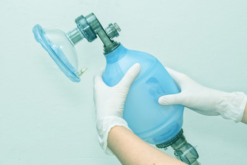 Doctor holding breathing bag (Ambu) and face mask