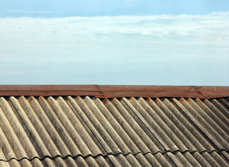 grey pitched roof slate on background blue sky