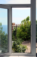 open modern white plastic window with view on sea horizon in sum