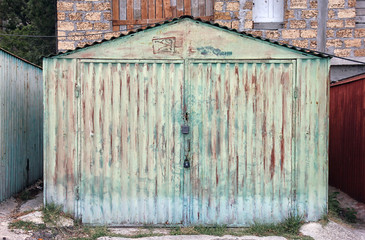 old rusty green metal car garage box