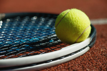 Tennis racket and ball on court