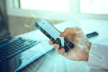 man's hands using smart phone in interior,flare light