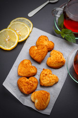 Homemade heart shape cookies and tea on the table