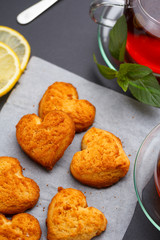 Homemade heart shape cookies and tea on the table