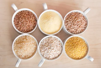 Fotobehang Different kinds of cereals: oats, millet, rice, buckwheat, wheat, spelt  © Maresol