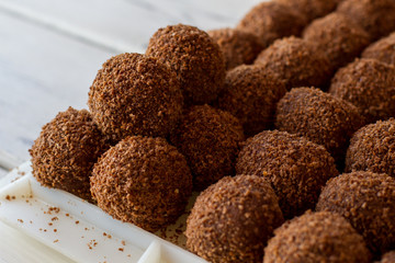 Brown ball shaped sweets. Rows of candies. Dessert from russian cuisine. Crumbled biscuits and butter.