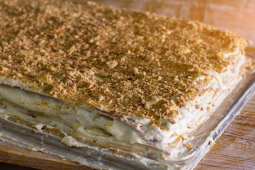 Layered dessert with cream. Lots of biscuit crumbs. Easy recipe of millefeuille. Freshly made cake.