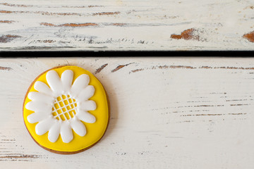 Cookie with picture of flower. Yellow and white icing. Beauty of plain things. Tasty biscuit with glaze.