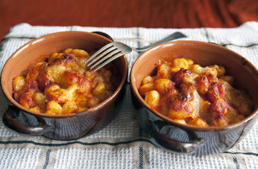 Pots with baked gnocchi with sauce 