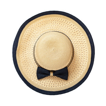 Pretty straw hat with ribbon and bow on white background. Beach hat close up top view isolated