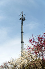 Close up white color antenna repeater tower on blue sky, selecti