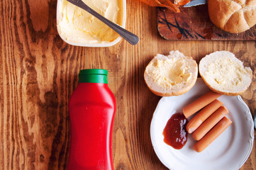 Cooked sausages on a wooden background with space for text