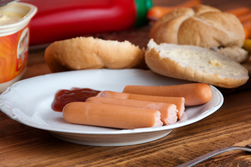 Cooked sausages on a wooden background with space for text