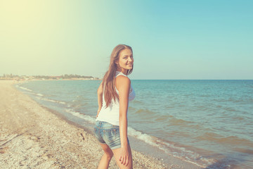 Young cheerful girl on the sea
