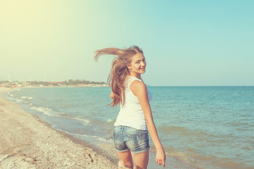 Young cheerful girl on the sea