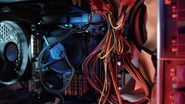 fly through a computer case showing the inside electronics with spinning fans