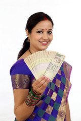Happy young traditional woman holding Indian currency - 121381167