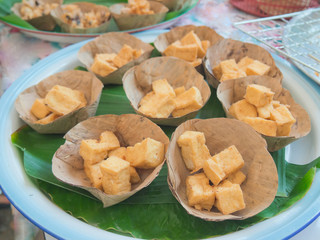Fried cube shape tofu served in cups of dried banana leaf