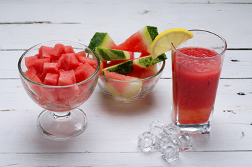 Slices of juicy watermelon into a bowl of watermelon and a glass