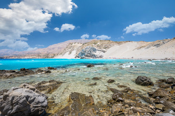 Agios Pavlos Beach in Crete island, Greece. Tourists relax and bath in crystal clear water of St. Paul Sandhill Beach.