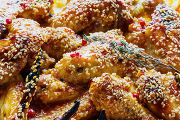Chicken wings marinated in tomato and honey sauce. Baked with sesame seeds.