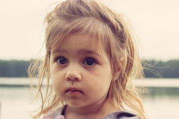 Toned closeup portrait of beautiful girl with big sad eyes