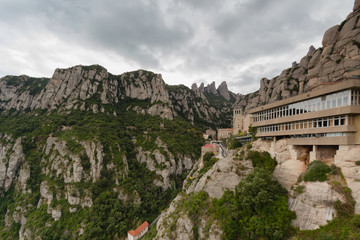 Fototapeta premium Monserrat, Spain, September 20th, 2016: Santa Maria de Montserrat Abbey Abadia de Montserrat. view from path Camí de la Santa Cova