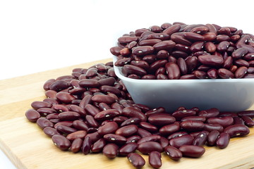 Red bean in white plastic bowl and wooden table. Ingredient bean