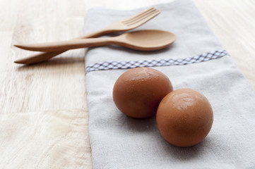 Fresh eggs and thai chilli on wood background, selective focus a