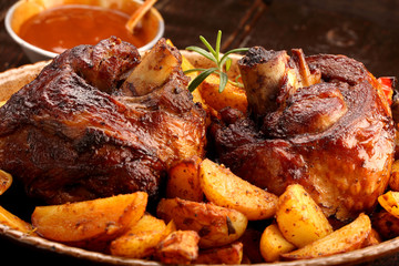Grilled barbecue meat with baked potato and dip
