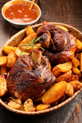 Grilled barbecue meat with baked potato and dip