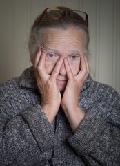 Portrait of elderly woman in glasses. Toned